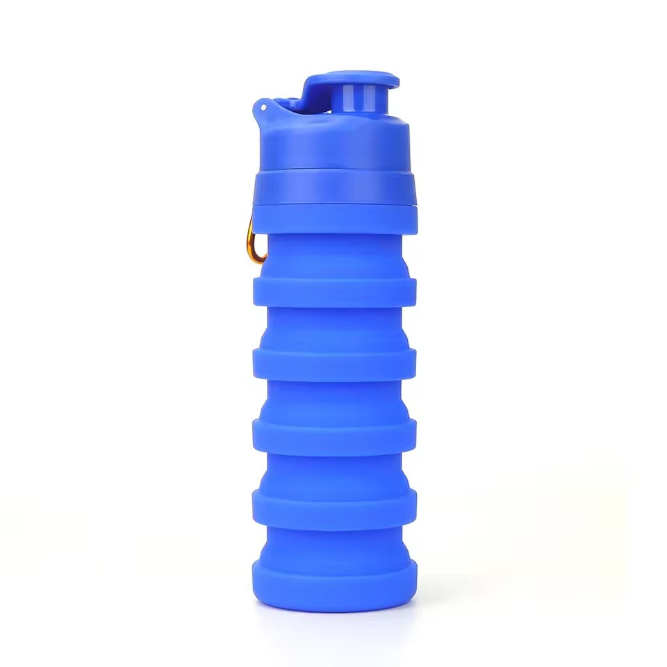 Blue 500ml collapsible silicone water bottle with flip-top sport cap and metal carry ring, on a white background