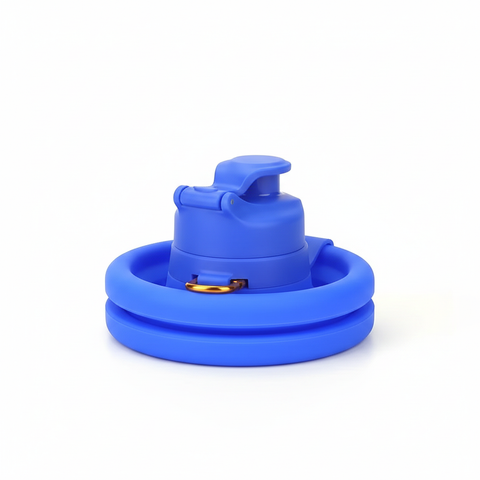 Blue collapsible silicone water bottle collapsed flat with metal carry ring on cap, on pure white background