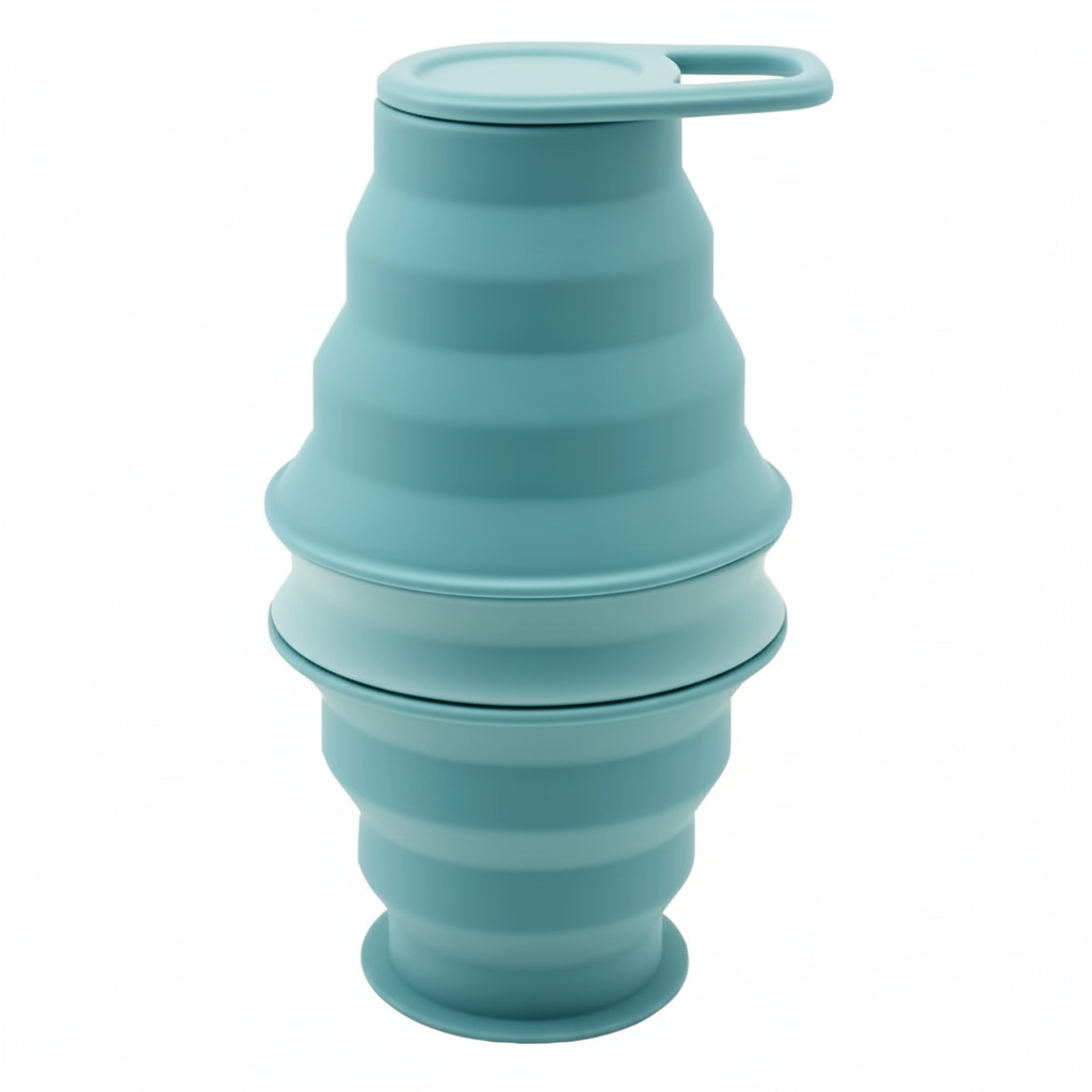 Mint collapsible silicone water bottle collapsed down short and secured with its carry-loop cap, on pure white background